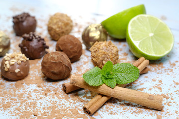 Tasty truffles, cinnamon sticks , cutting lime and fresh mint