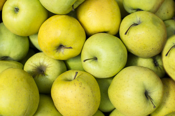 Green apples background. Group of green apples piled up. Fruty bacground.
