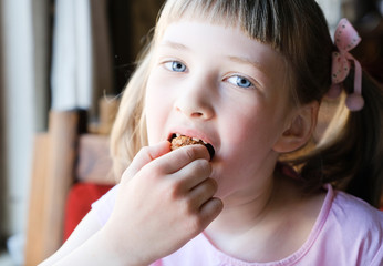 Pretty girl eating a truffle