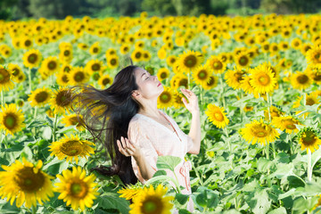 portrait Asia women in sunflower garden