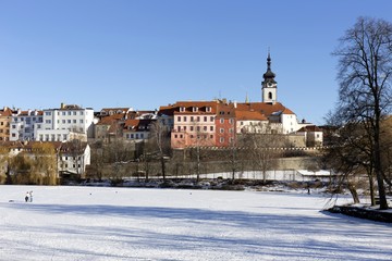 Colorful royal snowy medieval Town Pisek above the frozen river Otava, Czech Republic 