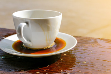 Spicy coffee clock and news paper on old wooden table nature background