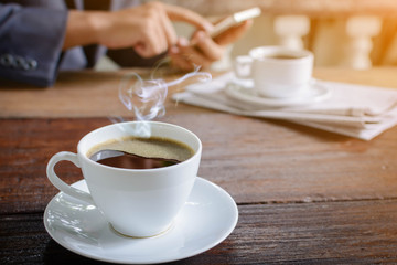 coffee cup clock and news paper on old wooden table nature background