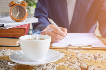 coffee cup clock and newspaper work on table