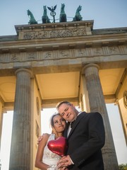 Smiling newlywed couple at Brandenburger Gate in Berlin © arianarama