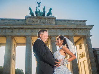 Smiling newlywed couple at Brandenburger Gate in Berlin © arianarama