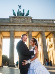 Smiling newlywed couple at Brandenburger Gate in Berlin © arianarama
