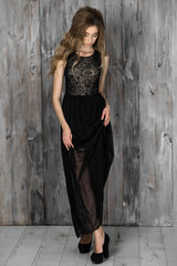 Beautiful elegant lady in a black long evening dress