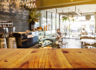 Wooden board empty table in front of blurred background. Perspective brown wood over blur in coffee shop or cafe and restaurant- can be used for display or montage your products.Mock up your products. - obrazy, fototapety, plakaty