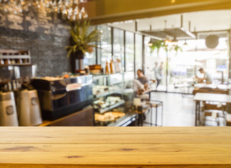 Wooden board empty table in front of blurred background. Perspective brown wood over blur in coffee shop or cafe and restaurant- can be used for display or montage your products.Mock up your products.