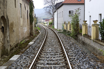 Fototapeta na wymiar rail track between houses
