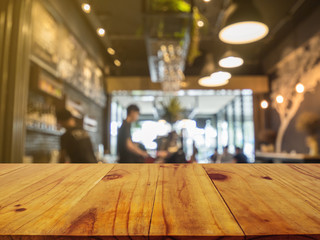 Wooden board empty table in front of blurred background. Perspective brown wood over blur in coffee shop or cafe and restaurant- can be used for display or montage your products.Mock up your products.