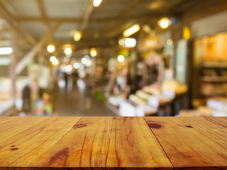 Wooden board empty table in front of blurred background. Perspective brown wood over blur in market or market on street- can be used for display or montage your products.Mock up your products.Vintage