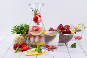 Cold fresh  homemade  lemonade with strawberry and herbs. Detox soda water recipe