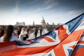 union jack flag and people walking on Millennium bridge at St Paul's cathedral - general elections, London, UK