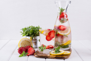 Fruit and herb infused water. Cold refreshing vitamin detox water. Summer drink