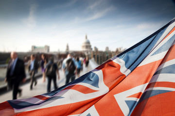 union jack flag and people walking on Millennium bridge at St Paul's cathedral - general elections, London, UK