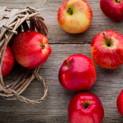 Ripe red apples on wooden background.