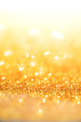Gold light bokeh texture or glitter lights festive gold background. Christmas abstract template