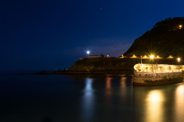 Lighthouse in fishing area at night