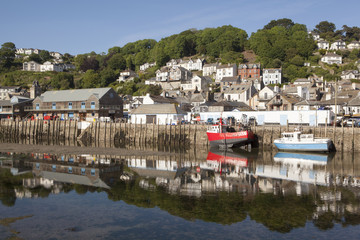 Low tide at Looe Cornwall with fishing boats moored at the fish quay on the East Looe river