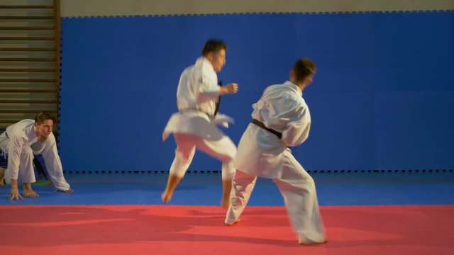Karate fighters practicing attack and blocking techniques at the dojo