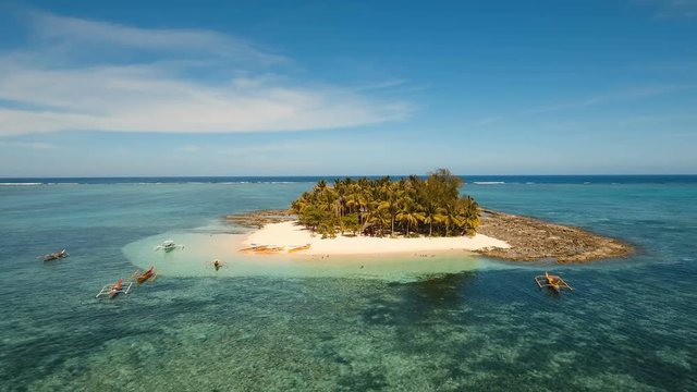 Aerial view of beautiful tropical island Guyam with white sand beach. View of a nice tropical beach from the air. Seascape: Ocean and beautiful beach paradise. Philippines. 4K video. Travel concept