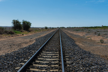 Train tracks passing through farming country