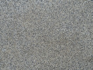 Flecked stone floor texture background.