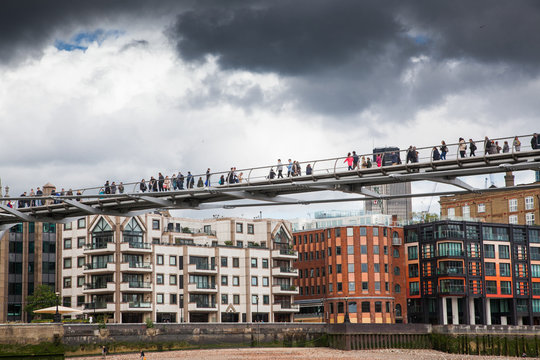 LONDON/UK - MAY 20 : Pedestrians crossing Millenium Bridge, London. View from the river