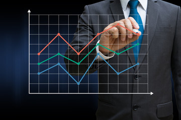 business man drawing the financial line charts showing growing revenue on touch screen