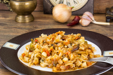 Fried cabbage with onions and paprika on plate