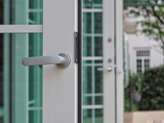 Door handle on the white door. Concept of modern interior design modern.