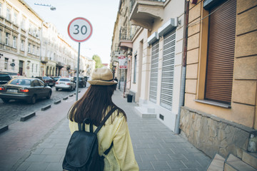 stylish woman walks on old city street