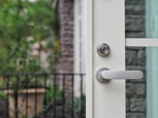 Door handle on the white door. Concept of modern interior design.