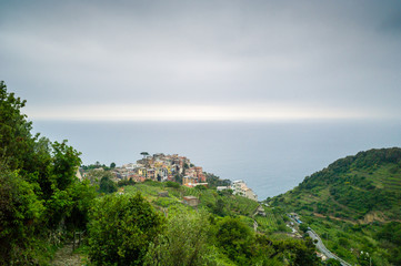 Fototapeta na wymiar The small village of Corniglia, with its colorful houses surrounded by the vineyards, is one of the five town of the Cinque Terre in Liguria.