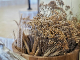 Dried flowers in the wooden bucket. Room decorate in vintage style.