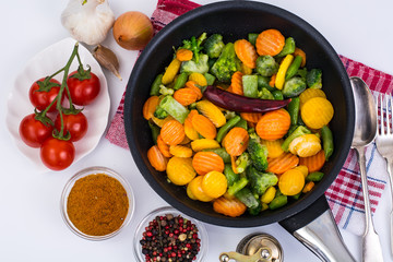 Frozen vegetables in frying pan for frying