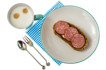 Cappuccino in blue cup and sandwich for breakfast