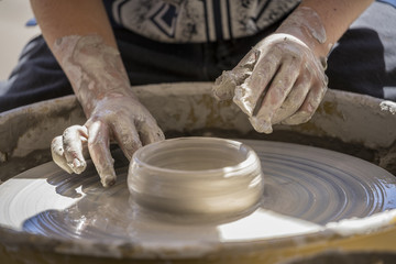 student using a pottery wheel 