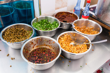 bowls with seasonings, spices and toppings