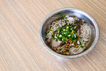 dish with udon noodles soup with pork in eatery
