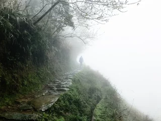 Outdoor kussens man at wet pathway on hill slope in rain © vvoe
