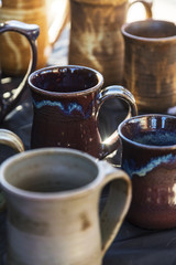 handmade pottery cups on a shelf 