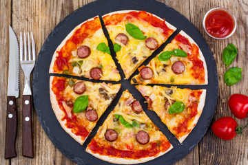 Crispy hot pizza on old wooden table