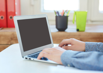 Male hand's taking notes on laptop close up.