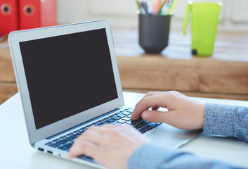 .Young male businessman taking notes on laptop.