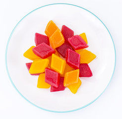 Multicolored fruit marmalade on white background