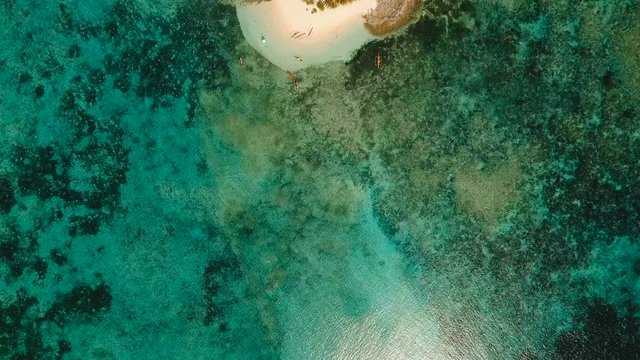 Aerial view of beautiful tropical island Guyam with white sand beach. View of a nice tropical beach from the air. Seascape: Ocean and beautiful beach paradise. Philippines. 4K video. Travel concept