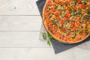cooked pizza on a wooden background top view